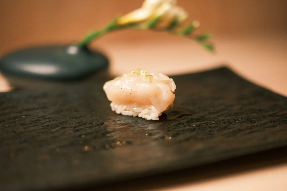 Beautifully plated sushi course paired with sake at Atto Sushi